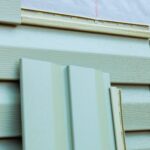 homeowner-installing-new-exterior-siding-panels-on-2025-03-27-05-01-36-utc-min
