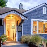 illuminated-front-stoop-and-of-blue-house-2025-04-03-23-28-33-utc-min